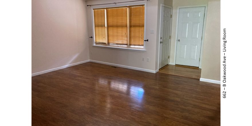 Living room with wood-style flooring and large window