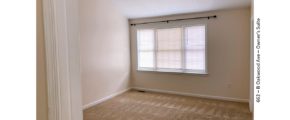 Unfurnished, carpeted bedroom with large window