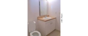 Bathroom with toilet, vanity, and mirror