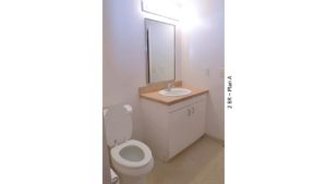 Bathroom with toilet, vanity, and mirror