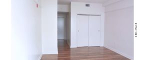 Unfurnished bedroom with wood-style floors and closet
