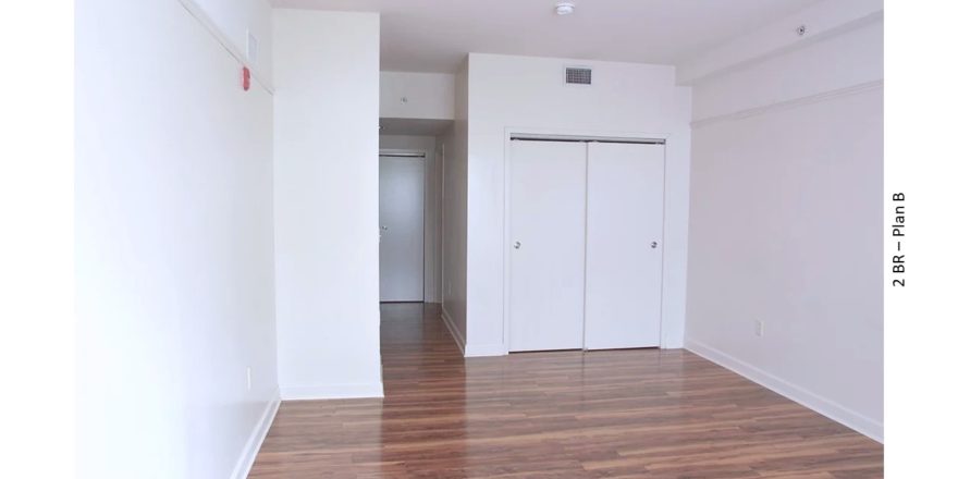 Unfurnished bedroom with wood-style floors and closet