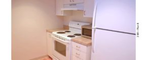 Kitchen with white cabinets and white appliances