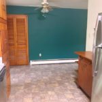 Kitchen with wood-tone cabinets, stainless steel appliances and ceiling fan