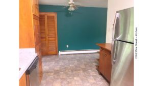 Kitchen with wood-tone cabinets, stainless steel appliances and ceiling fan