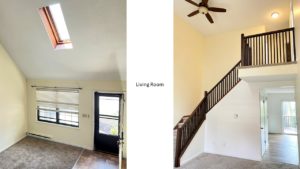 Carpeted, unfurnished living room with staircase, large windows and cathedral ceiling