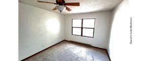 Carpeted bedroom with ceiling fan and large window