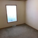 Unfurnished, carpeted bedroom with a window