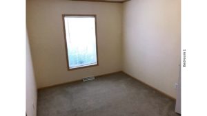 Unfurnished, carpeted bedroom with a window