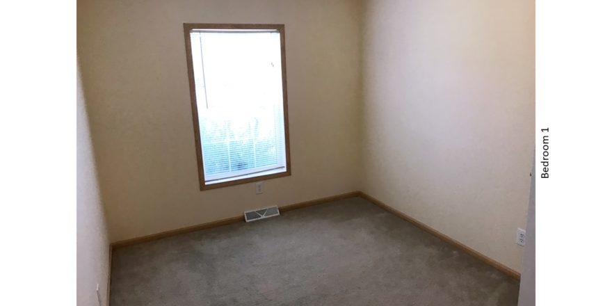 Unfurnished, carpeted bedroom with a window