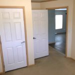 Unfurnished, carpeted bedroom with closet