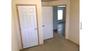 Unfurnished, carpeted bedroom with closet