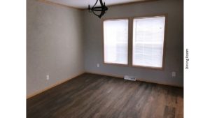 Unfurnished dining room with large windows, chandelier and LVP/LVT floor.