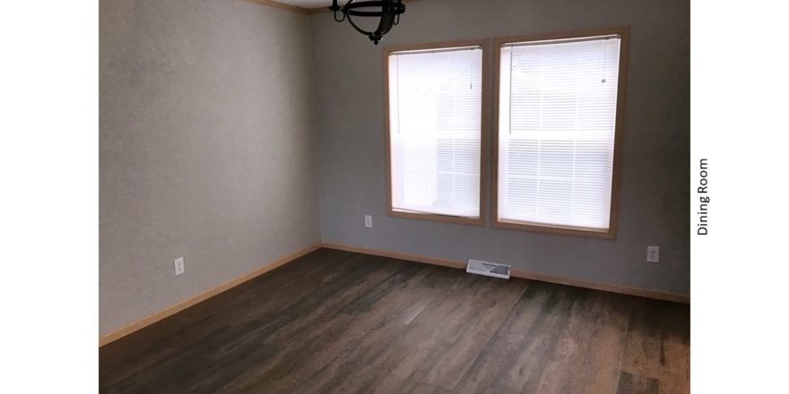 Unfurnished dining room with large windows, chandelier and LVP/LVT floor.