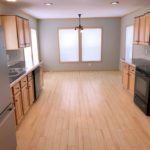 Kitchen with black and stainless steel appliances and wood-tone cabinets