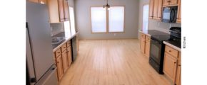 Kitchen with black and stainless steel appliances and wood-tone cabinets