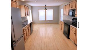 Kitchen with black and stainless steel appliances and wood-tone cabinets