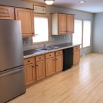 Kitchen with black and stainless steel appliances and wood-tone cabinets