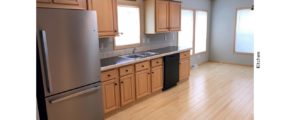 Kitchen with black and stainless steel appliances and wood-tone cabinets