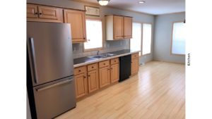 Kitchen with black and stainless steel appliances and wood-tone cabinets