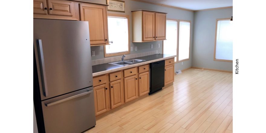 Kitchen with black and stainless steel appliances and wood-tone cabinets