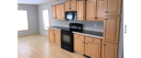 Kitchen with black and stainless steel appliances and wood-tone cabinets