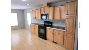 Kitchen with black and stainless steel appliances and wood-tone cabinets