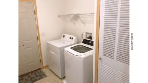 Laundry room with side-by-side top load washer and front load dryer