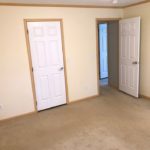 Unfurnished, carpeted bedroom with closet