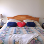 Bedroom with large bed and two nightstands each with a lamp
