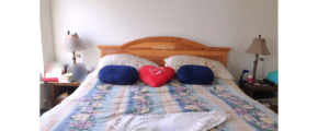 Bedroom with large bed and two nightstands each with a lamp