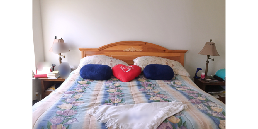 Bedroom with large bed and two nightstands each with a lamp