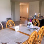 Kitchen with table, island and view of front door