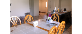 Kitchen with table, island and view of front door