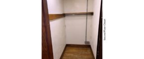 Closet with hardwood floors and clothes bar and shelf