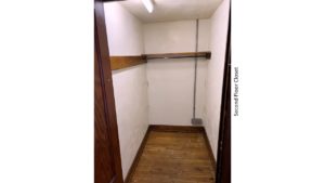 Closet with hardwood floors and clothes bar and shelf