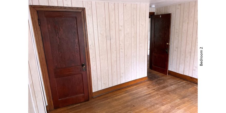 Unfurnished bedroom with hardwood floors and closet