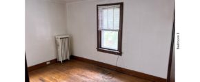 Unfurnished bedroom with hardwood floor and large window