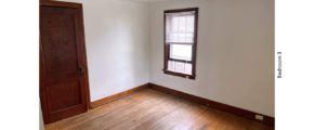 Unfurnished bedroom with hardwood floors, closet, and large window