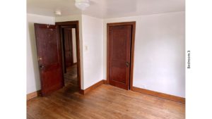 Unfurnished bedroom with hardwood floors and closet