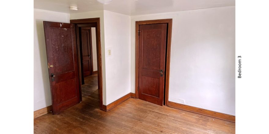 Unfurnished bedroom with hardwood floors and closet