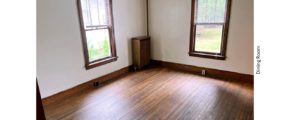 Unfurnished dining room with large windows and hardwood floors