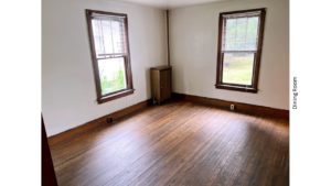 Unfurnished dining room with large windows and hardwood floors