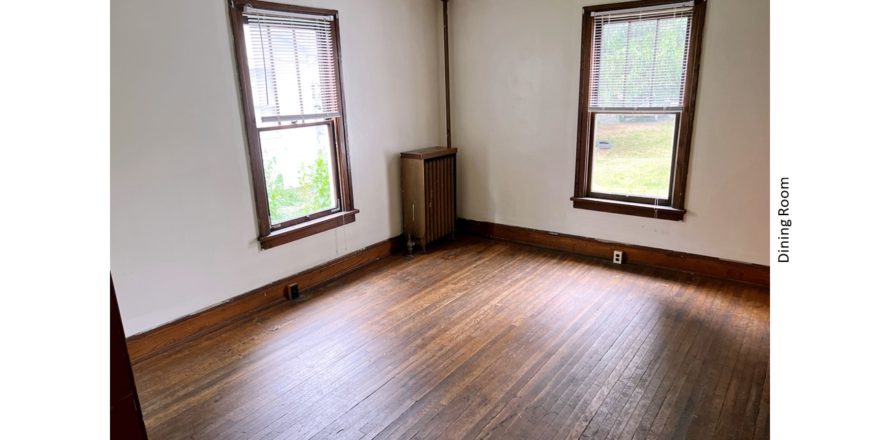 Unfurnished dining room with large windows and hardwood floors