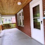 Covered front porch with railing