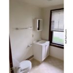 Half bathroom with vanity, toilet, and medicine cabinet