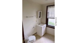 Half bathroom with vanity, toilet, and medicine cabinet