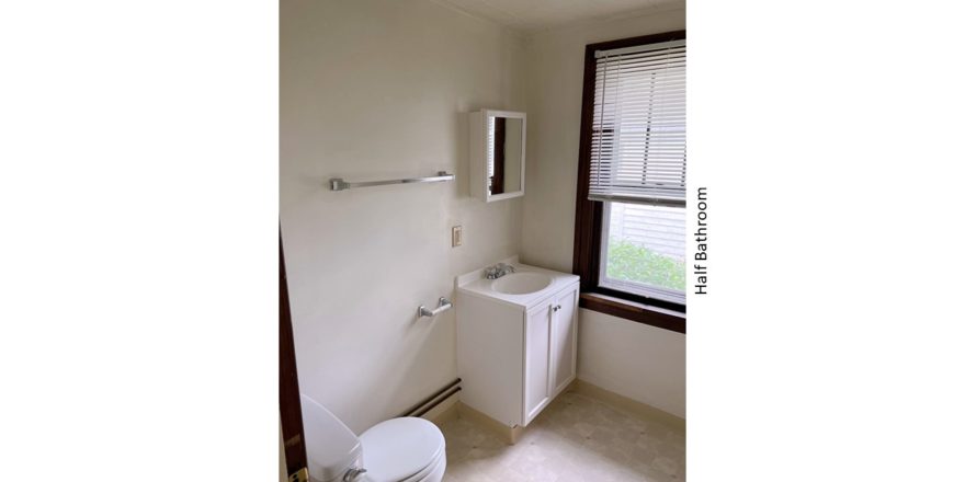 Half bathroom with vanity, toilet, and medicine cabinet