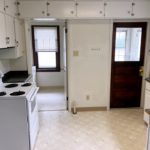 Kitchen with many cabinets and a white range oven