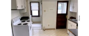 Kitchen with many cabinets and a white range oven